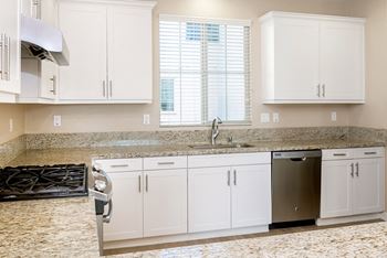 Kitchen with white cabinets and granite counter tops at Ocean Air, San Diego, 92130